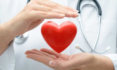 a doctor with a floating heart between her hands