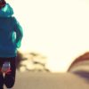 a woman running along an empty road