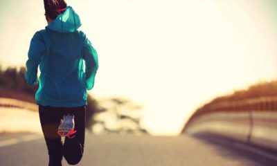 a woman running along an empty road