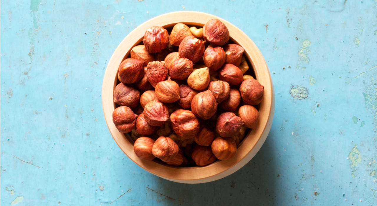 bowl of nuts on a blue background