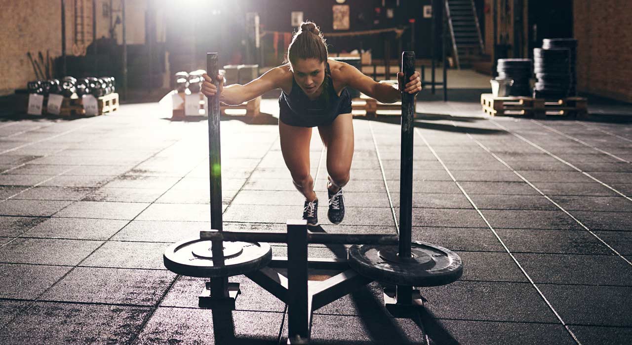 woman pushing the prowler sled