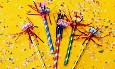 confetti and party blowers on a yellow surface