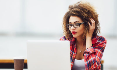 woman on her laptop wearing a checkered shirt