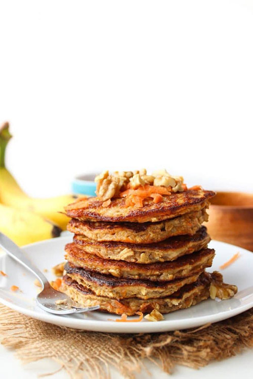 flourless carrot banana pancakes on a white plate with a fork