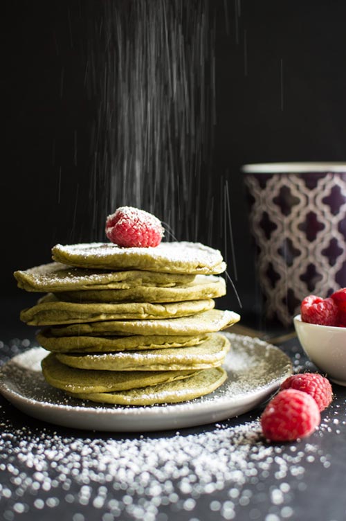 vegan green tea pancakes with raspberries and icing powder