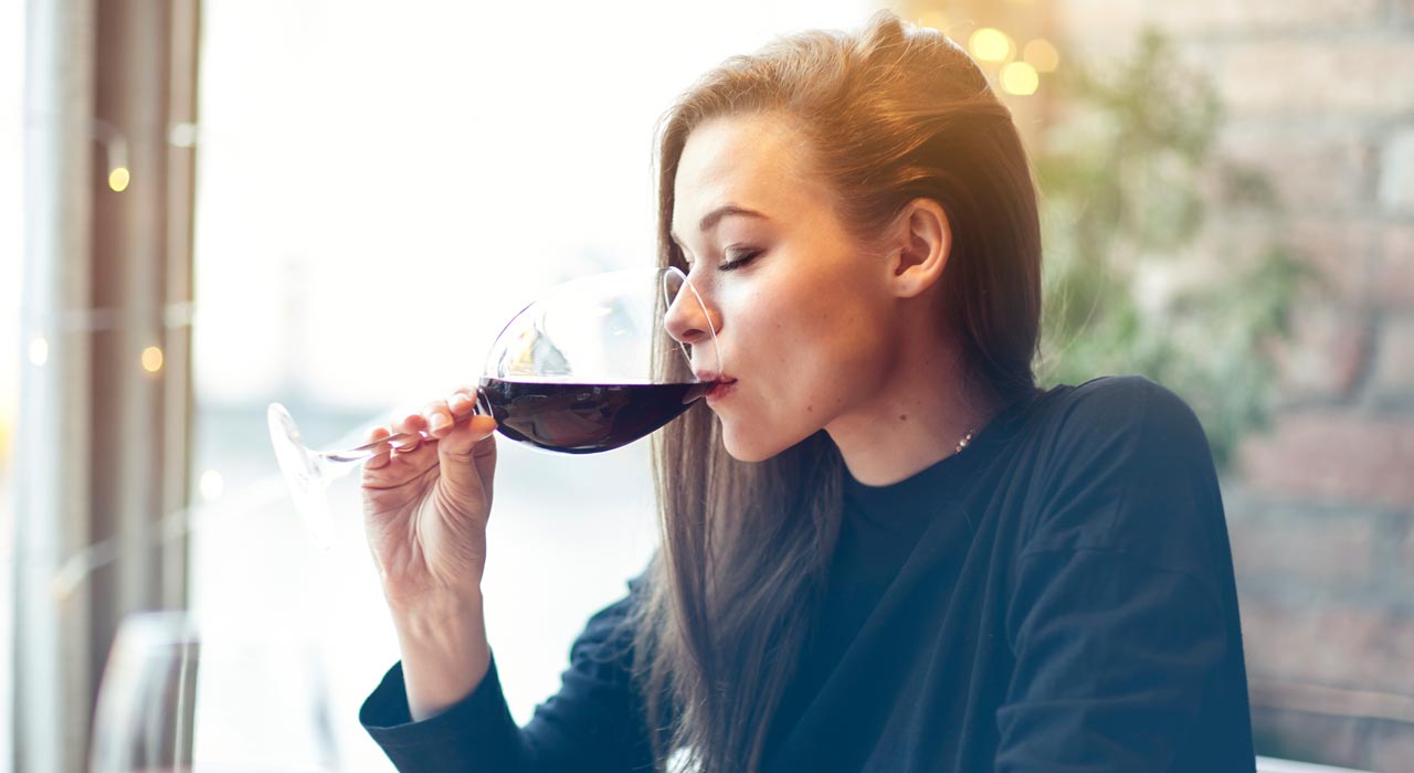 woman drinking a glass of red wine