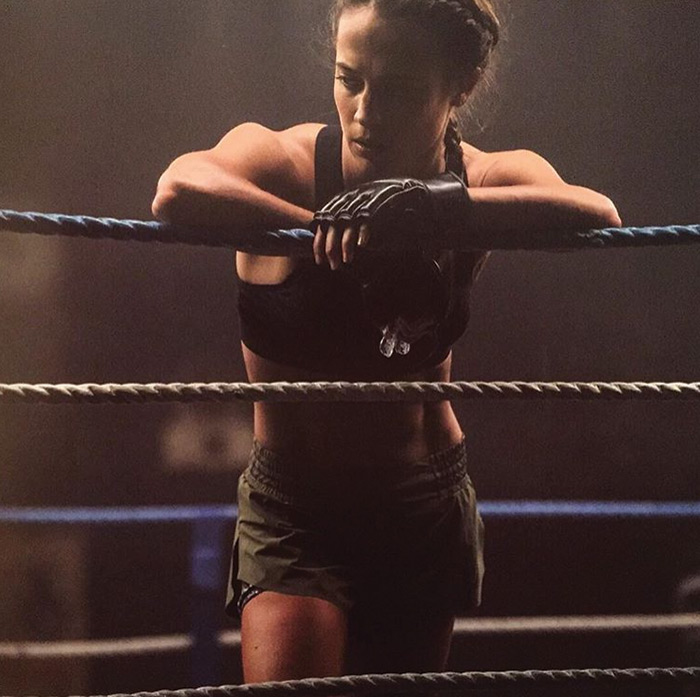 alicia vikander leaning on boxing ring ropes