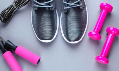 running shoes next to a pair of dumbbells and skipping ropes