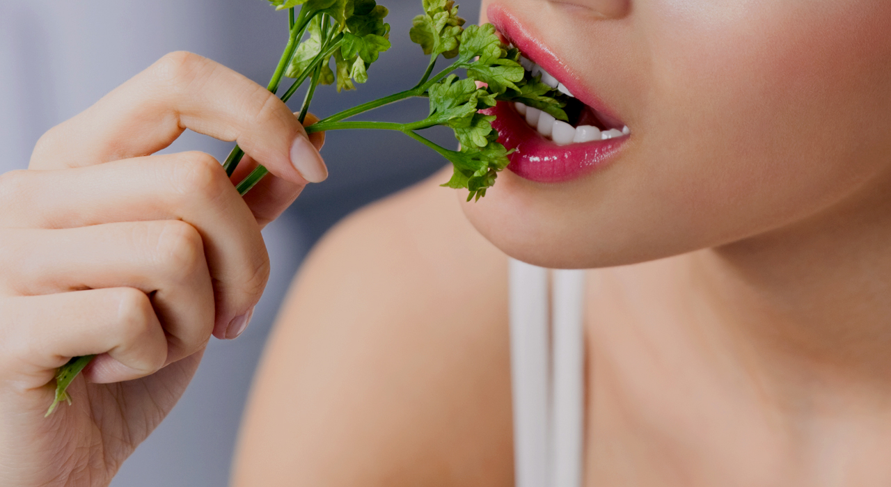 woman eating cilantro