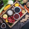 a tray of fruit and vegetables surrounded by fruit and vegetables