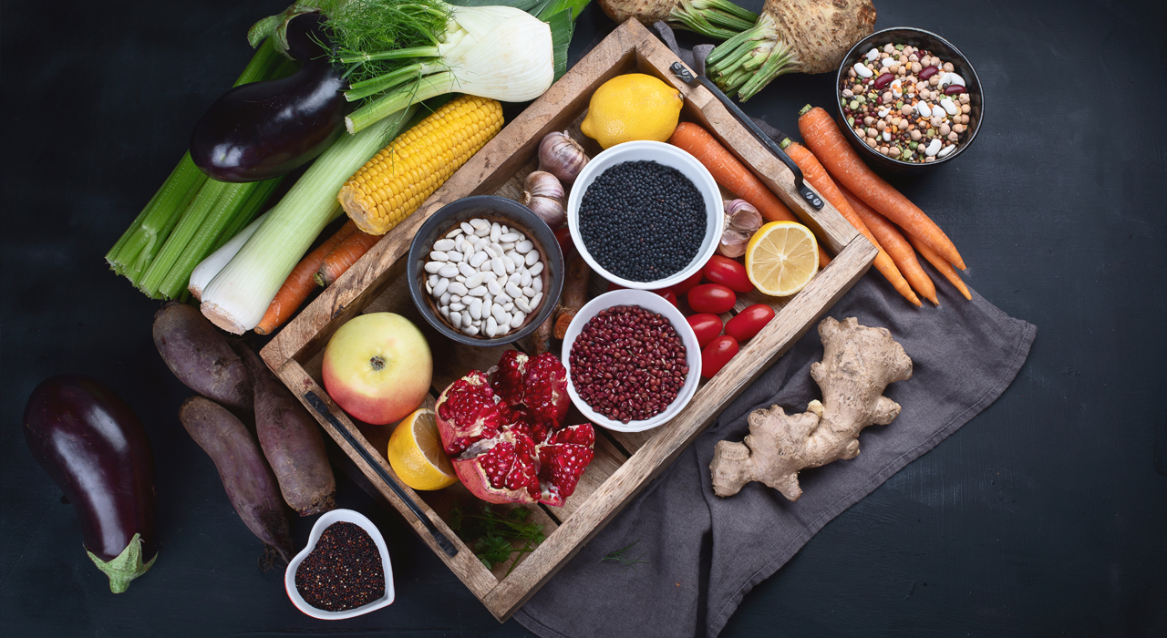 a tray of fruit and vegetables surrounded by fruit and vegetables