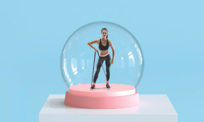 a fit woman performing exercises in a snow globe