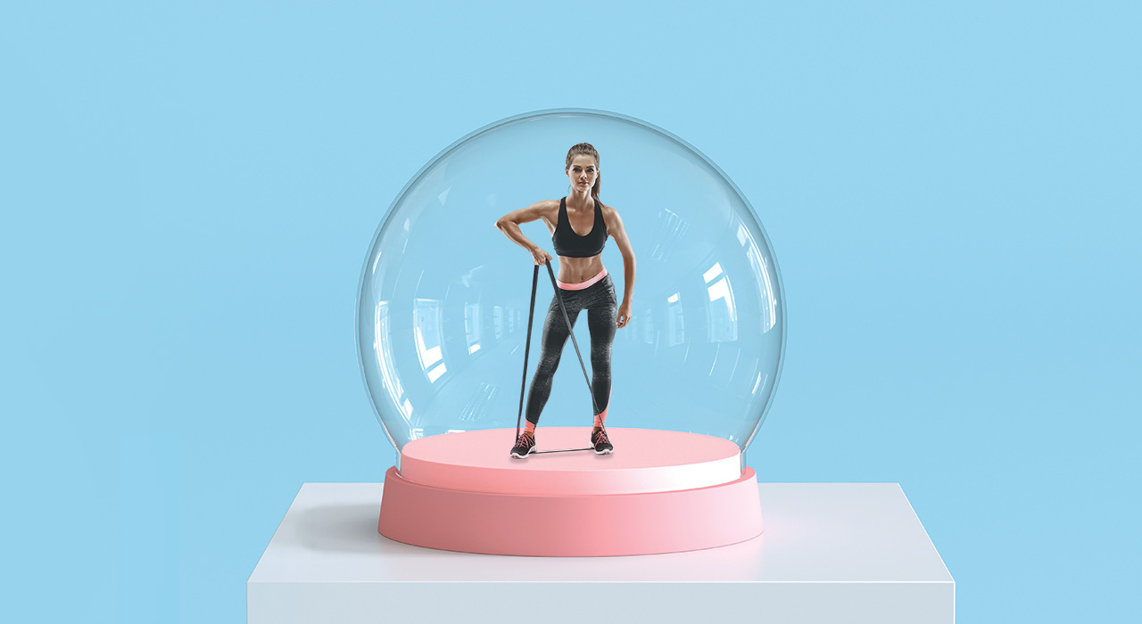 a fit woman performing exercises in a snow globe