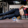 a woman foam rolling in the gym