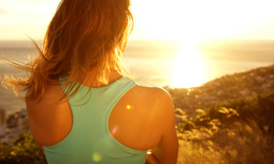 a woman standing looking into the sun