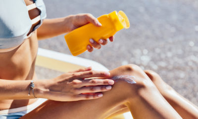 woman putting on sunscreen