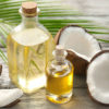 coconut oil in a small flask surrounded by a broken coconut