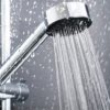 a silver shower head spurting out water