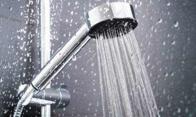 a silver shower head spurting out water