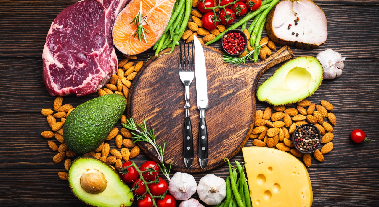 chopping board with a knife and fork on surrounded by food
