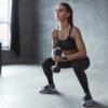 fit woman performing a goblet squat in a gym studio