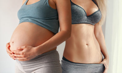 a pregnant woman next to a fit woman