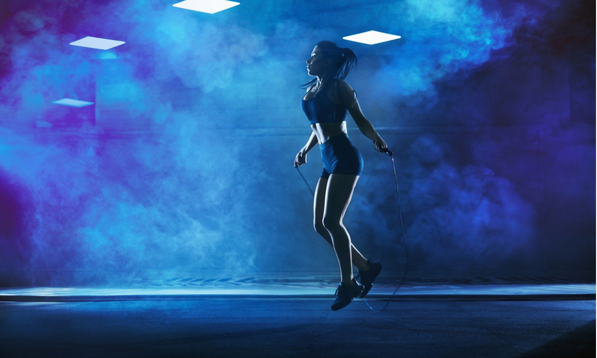 woman skipping in a room with blue lighting