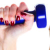 womans fist and womans hand holding dumbbell