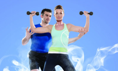 man and woman training with dumbbells