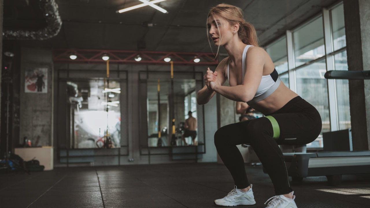 womsn performing exercise with resistance band