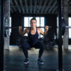 woman performing squat in gym