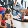 two young fit women performing glute exercises