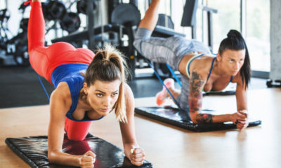 two young fit women performing glute exercises