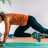 woman performing mountain climber exercise on exercise mat