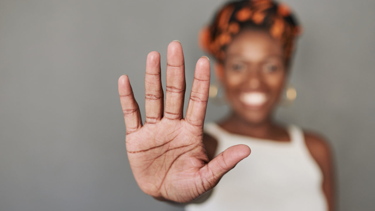 woman holding her palm out in front of her