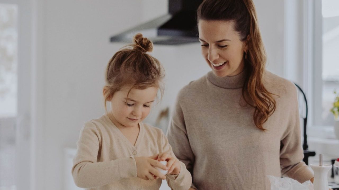 mother and daughter in kitchen cooking