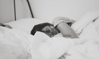 black and white image of woman sleeping in bed