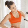 Sports woman with protein shaker at gym