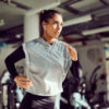 Determined athletic woman running on treadmill while practicing in a gym